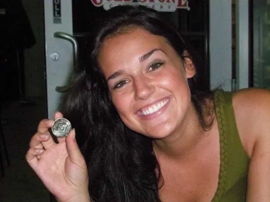 woman battling depression and addiction with 2 year sober coin