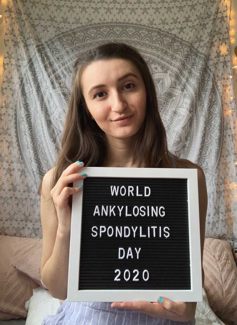 woman with "world ankylosing spondylitis day" sign