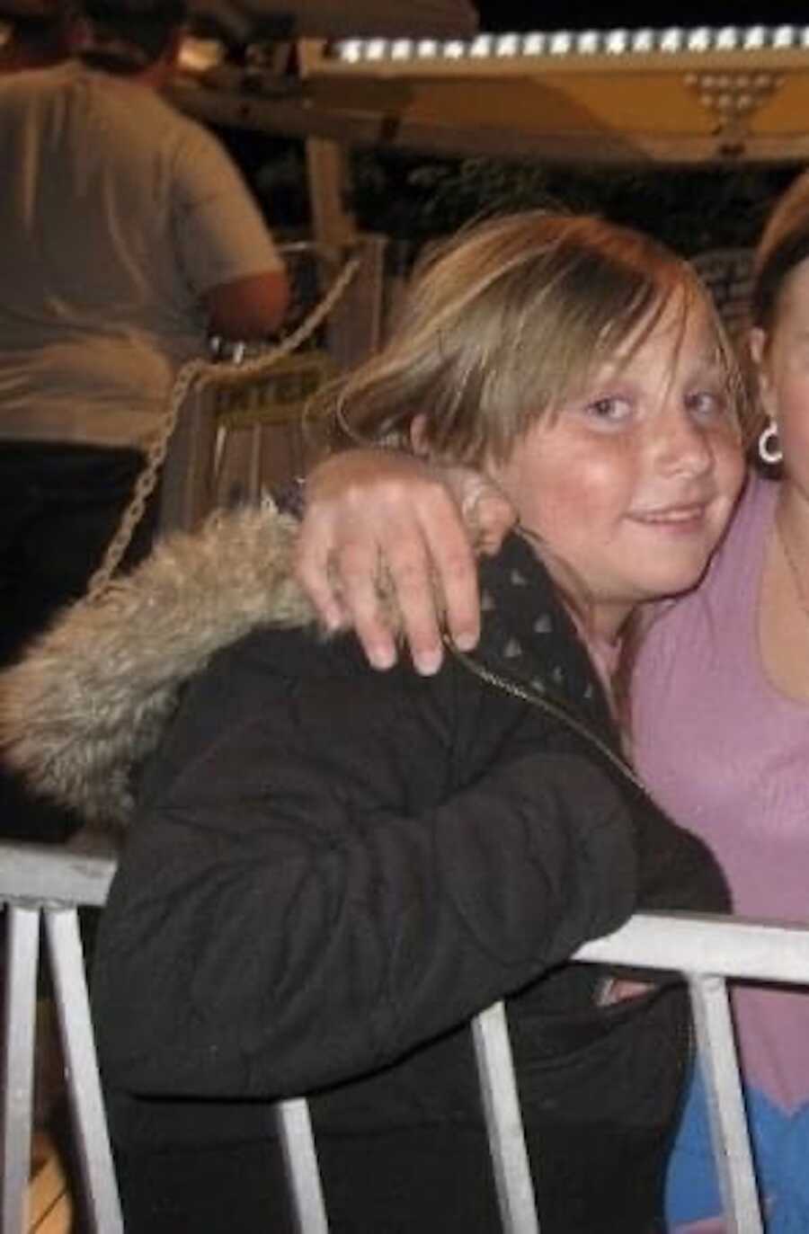 young girl sitting while wearing winter jacket