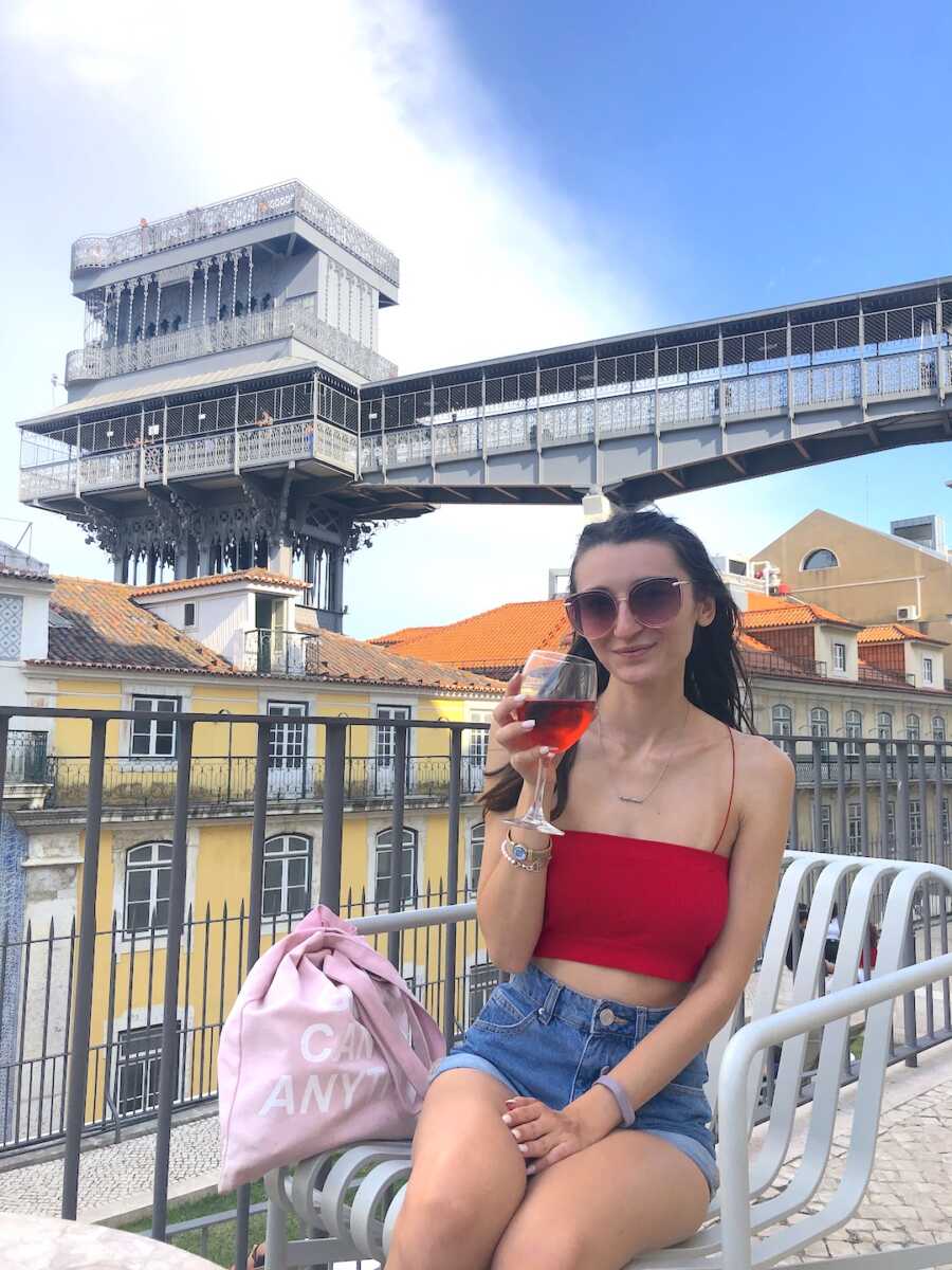 woman on rooftop drinking wine