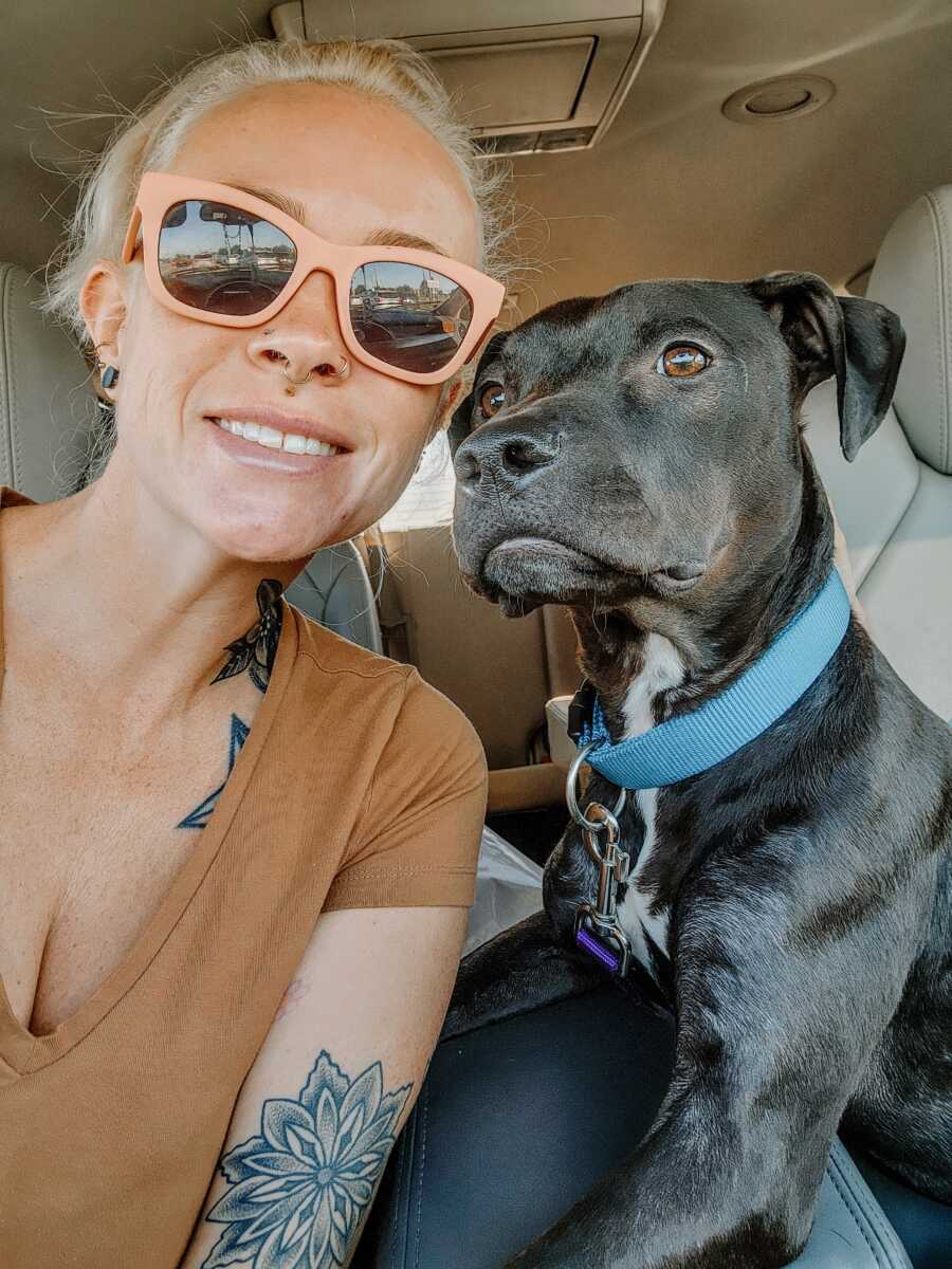 sober mom poses with dog in car