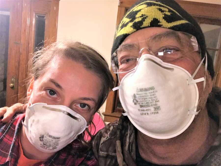 grieving daughter and father wearing dust face masks 