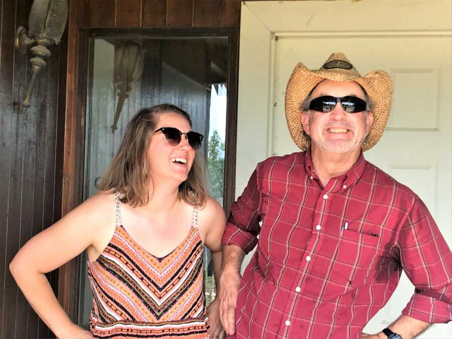 Grieving daughter laughing and acting goofy with father 