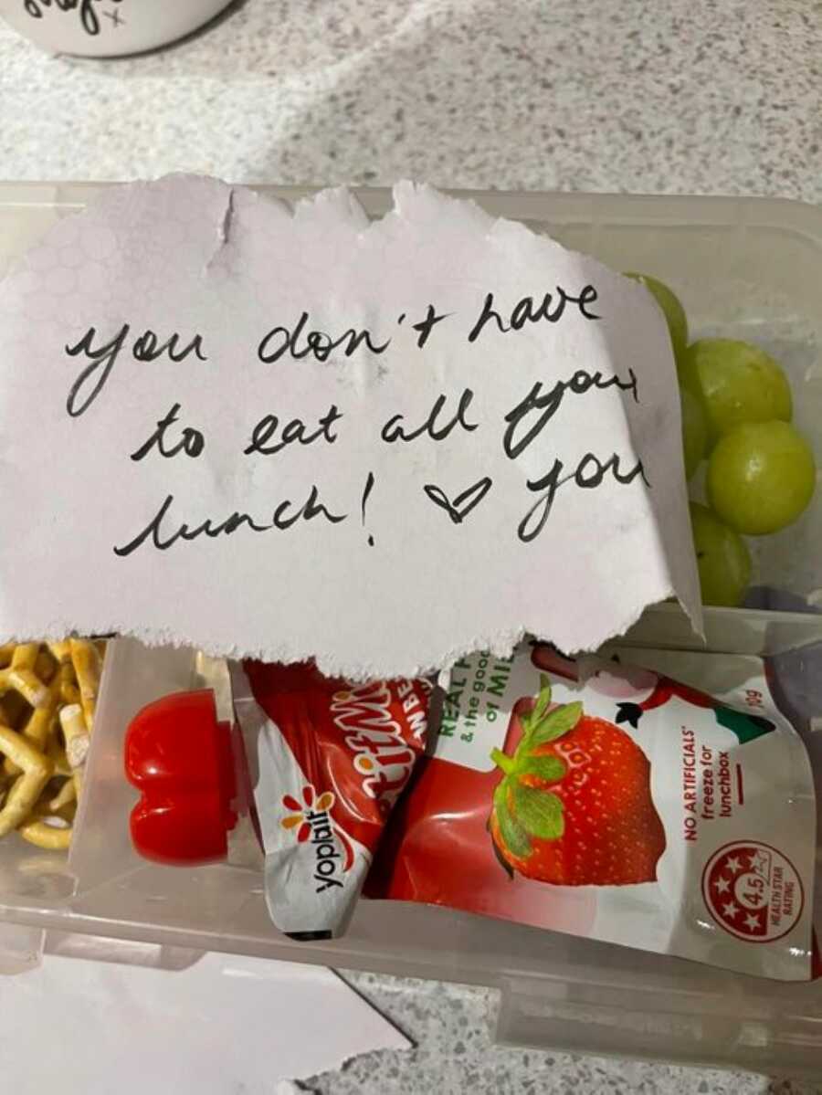 A written note saying "you don't have to eat all your lunch!" sat on top of lunch