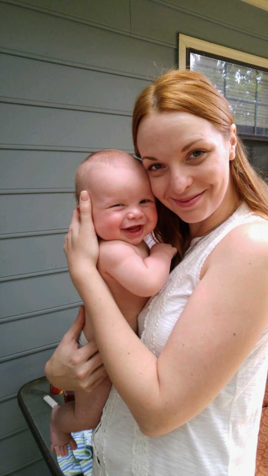 addict mother holding baby boy in diaper