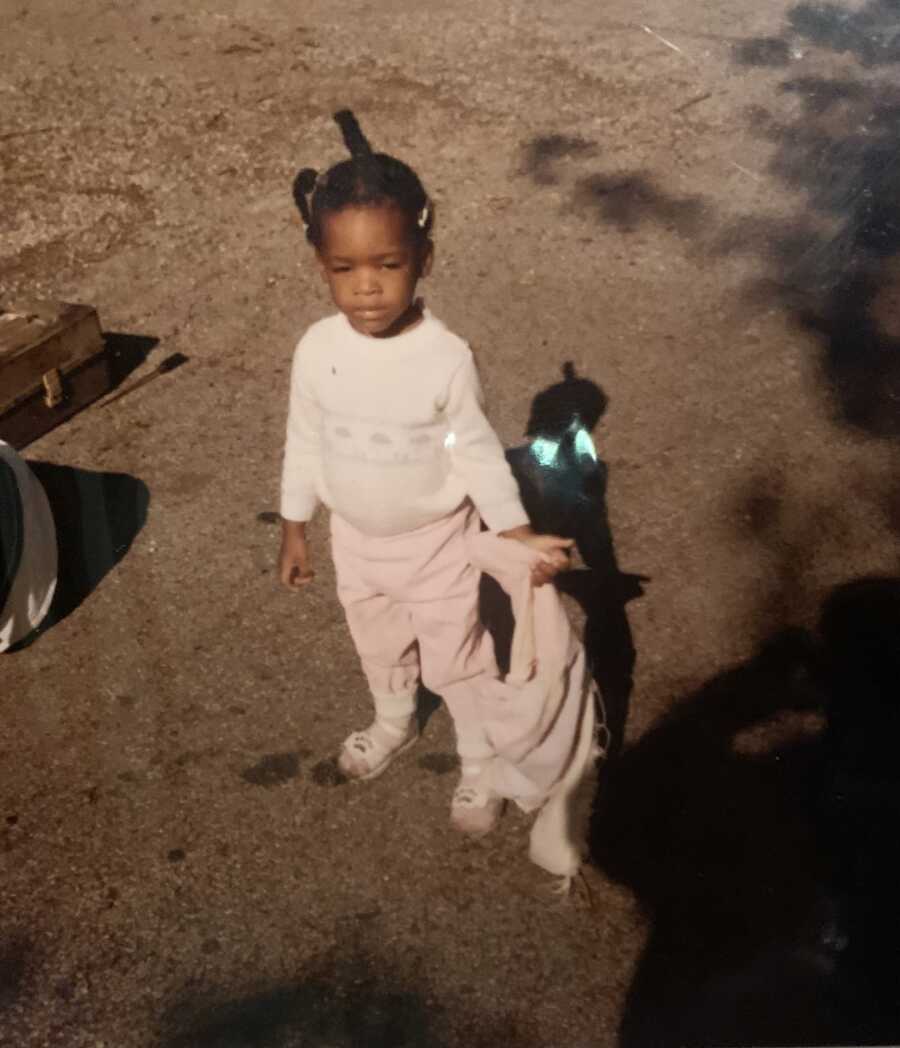 adoptee as a child holding a backpack