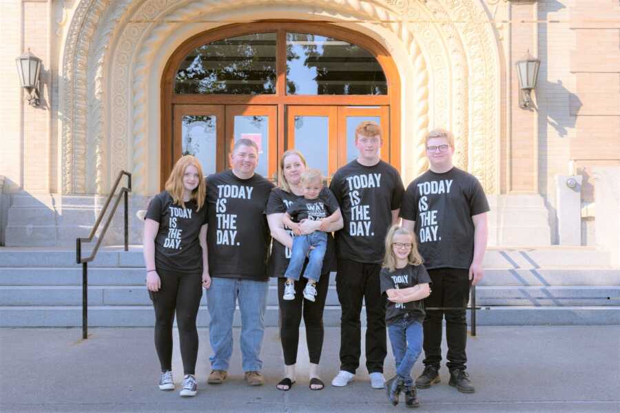 adoptive family in front of courthouse on adoption day