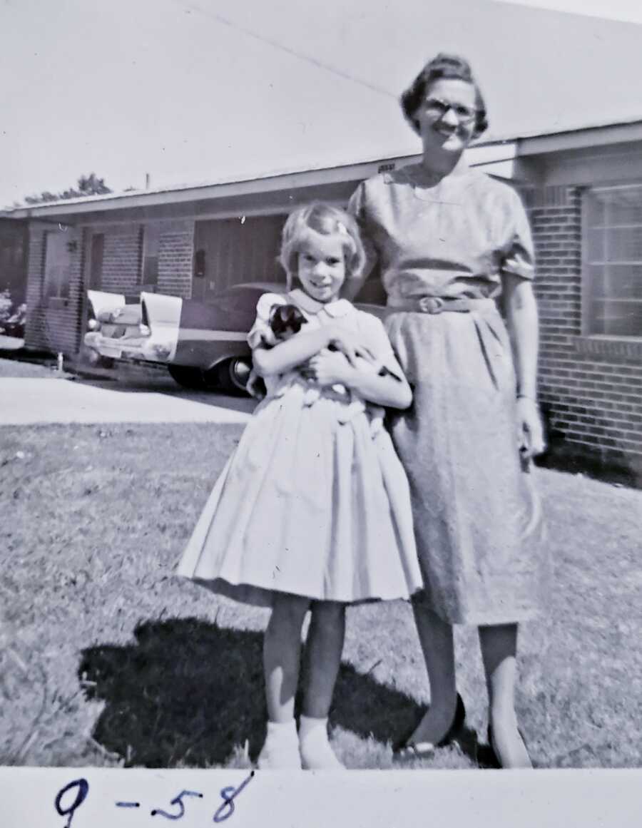 adoptive mom stands next to young daughter