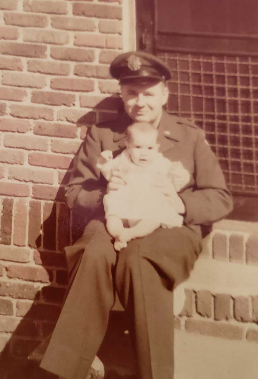 air force dad holds adopted baby girl