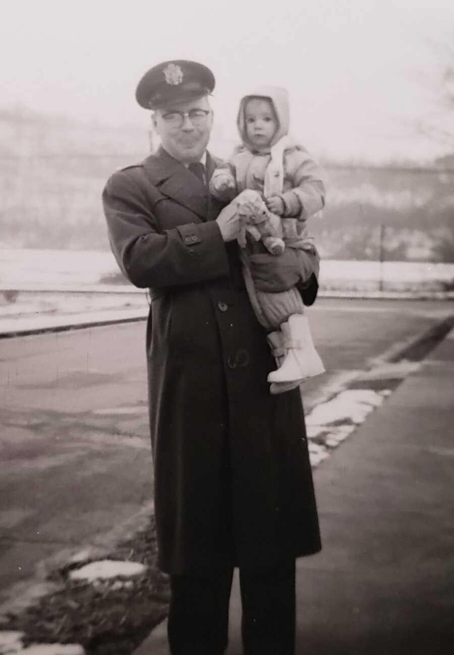 air force dad holds adopted daughter