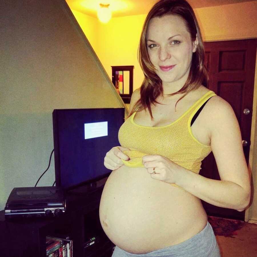 alcoholic pregnant woman showing belly in yellow tank top