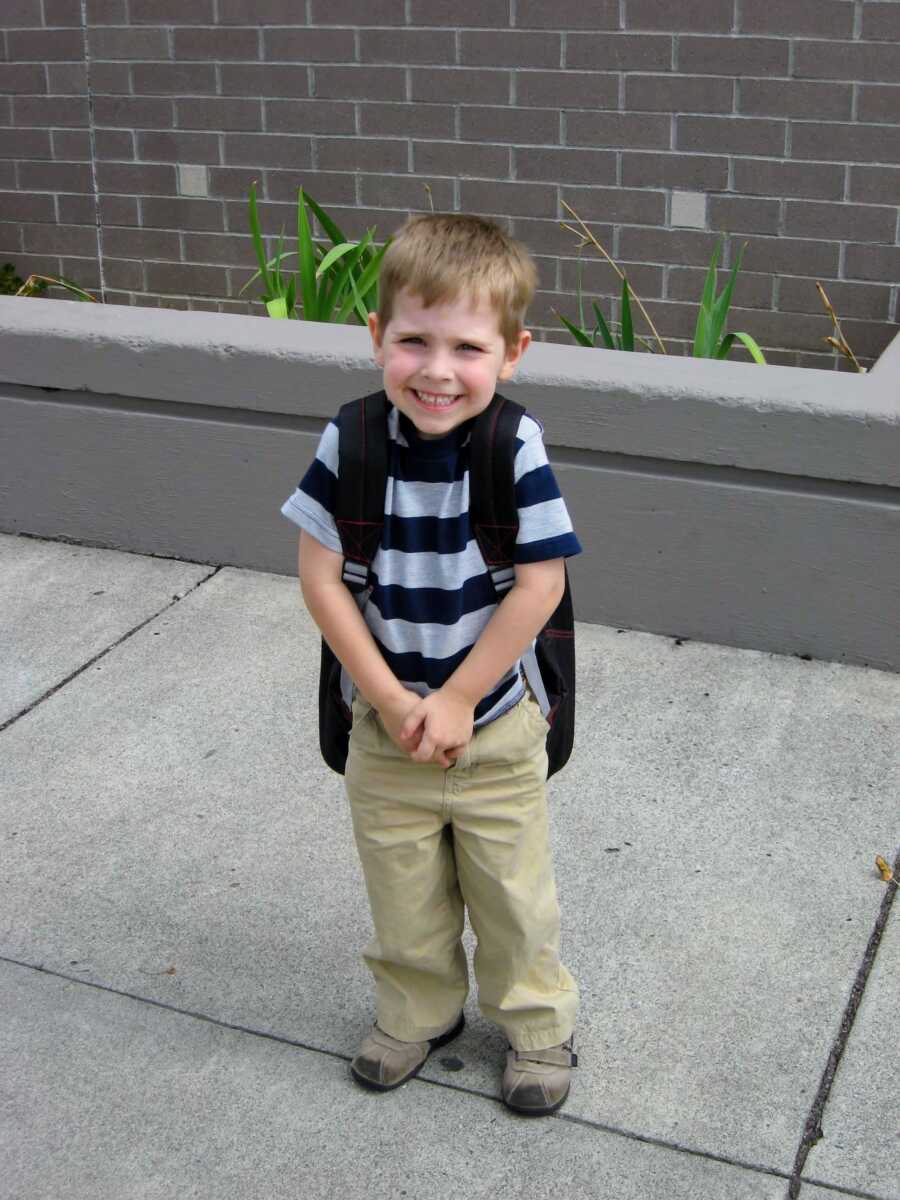 autistic boy outside on the first day of kindergarten