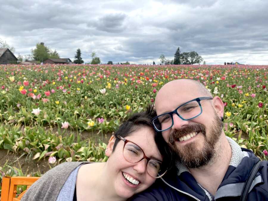 autistic chronically ill woman at tulip field with her partner