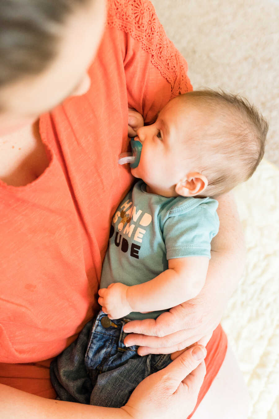 single foster mother holds a newborn baby boy placement