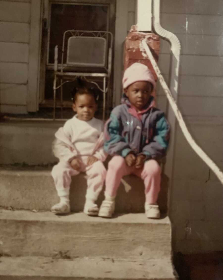 biological sisters sitting on steps together