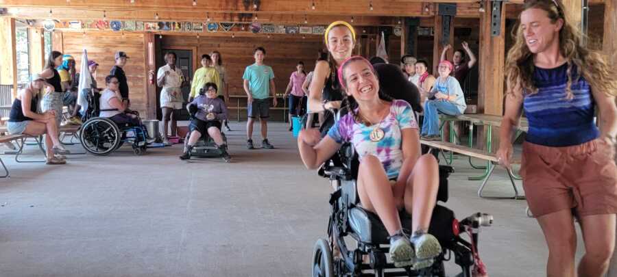 Campers play game in a recreation center in wheelchairs