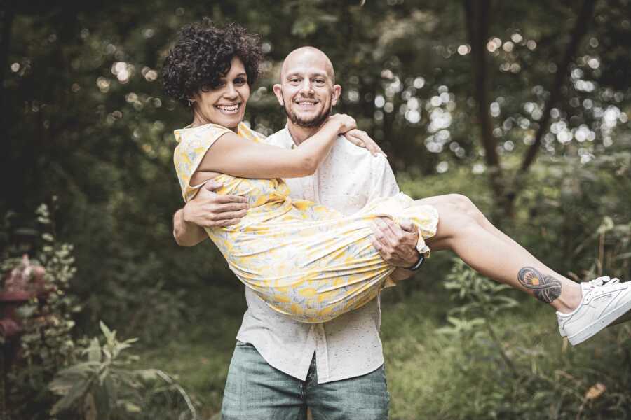 woman with epilepsy being carried by her supportive husband
