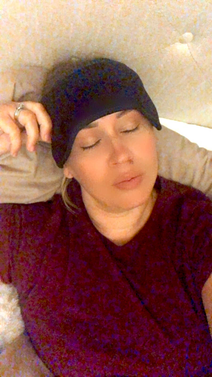 woman with chronic illness lays down with cool pack on head