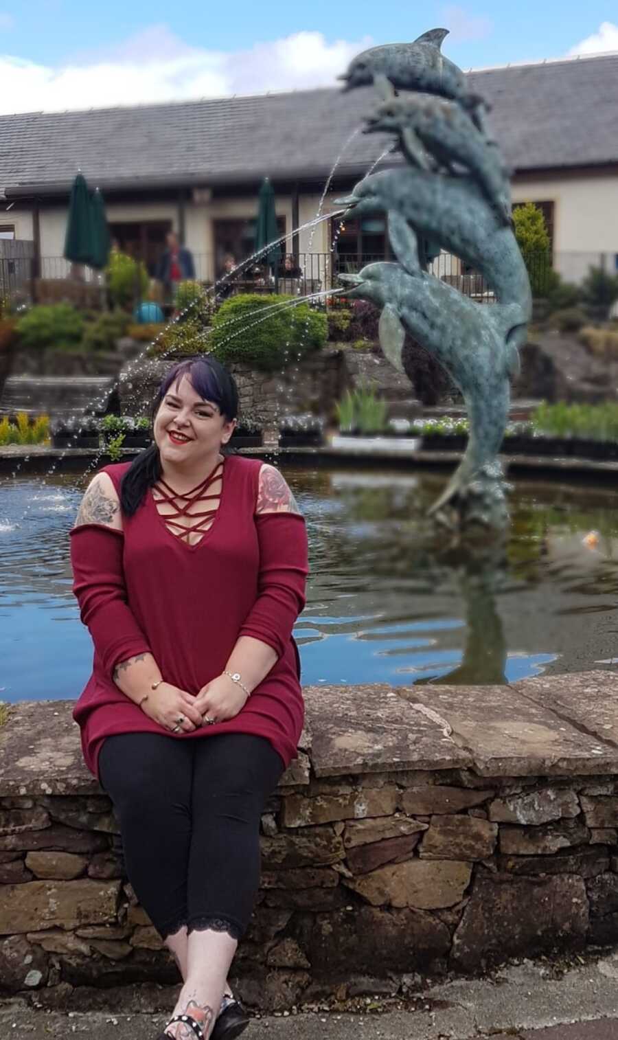 chronically ill woman sitting in front of fountain