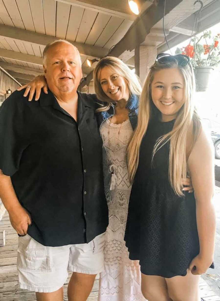 daughter stands with her mom and dad before their passing