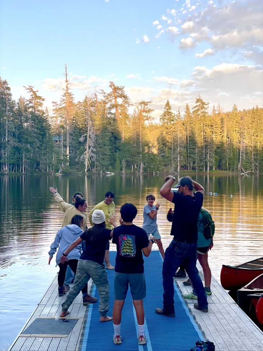 Disabled campers play a game on a dock