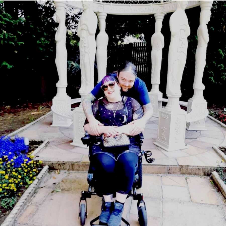 disabled chronically ill woman in her wheelchair with husband