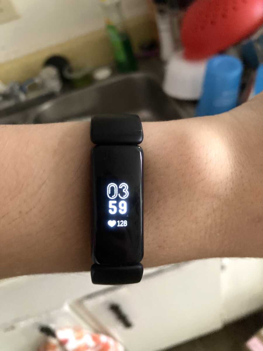 fitbit displaying the time and a high heart rate of 128