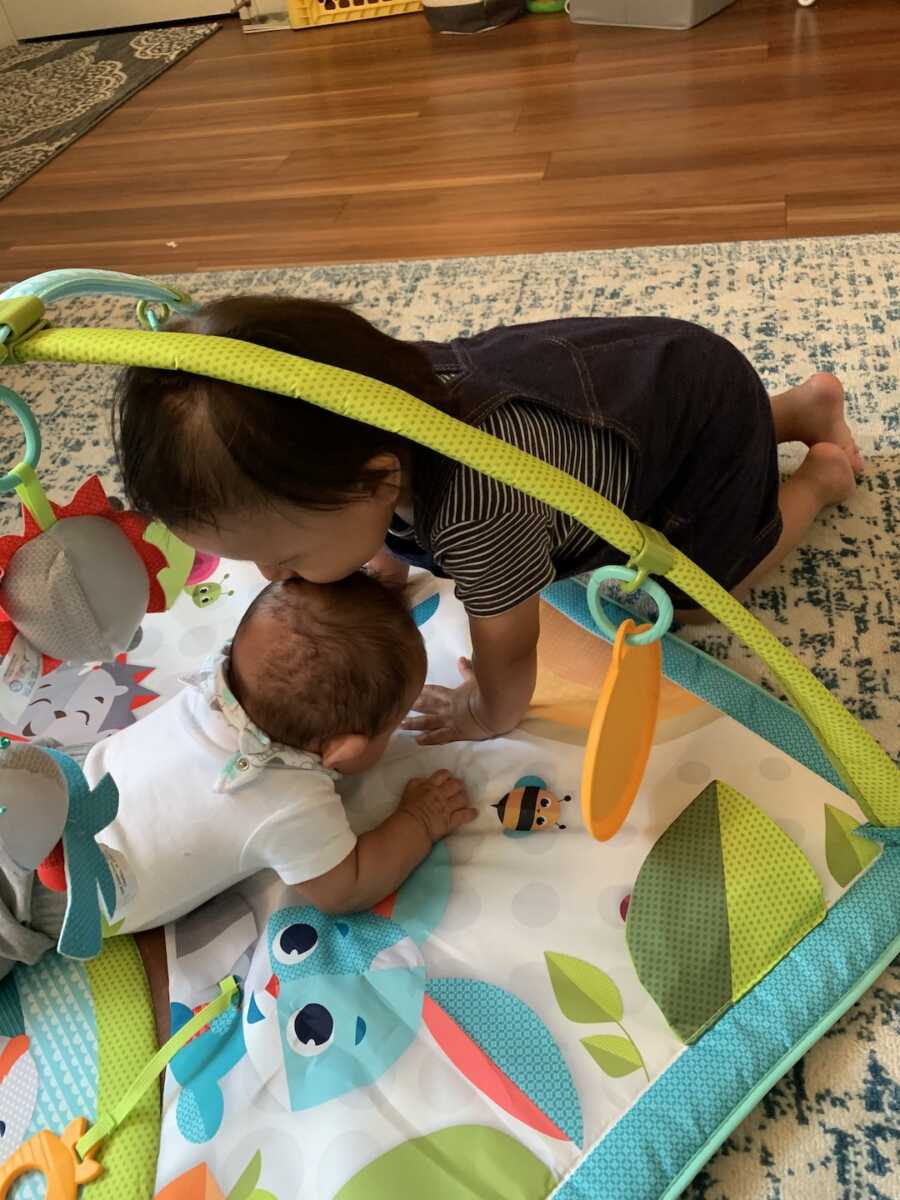 foster child kisses another foster child on the head