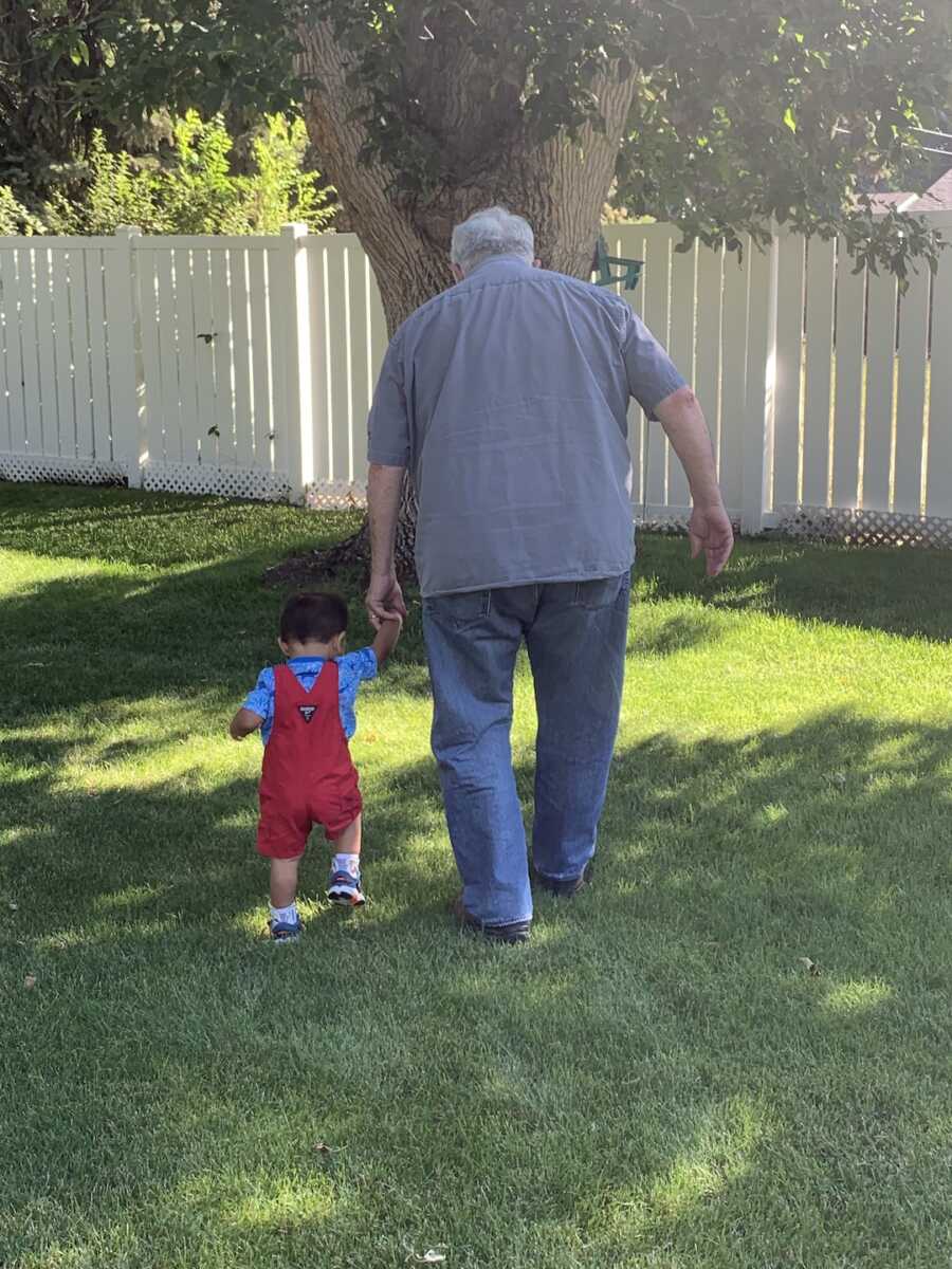 foster child walking with foster grandpa