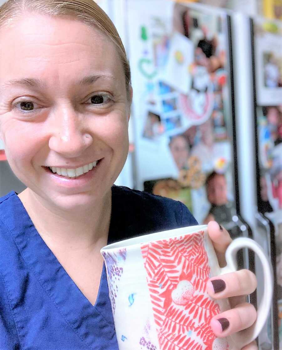 selfie of foster mom holding a coffee mug in the kitchen 