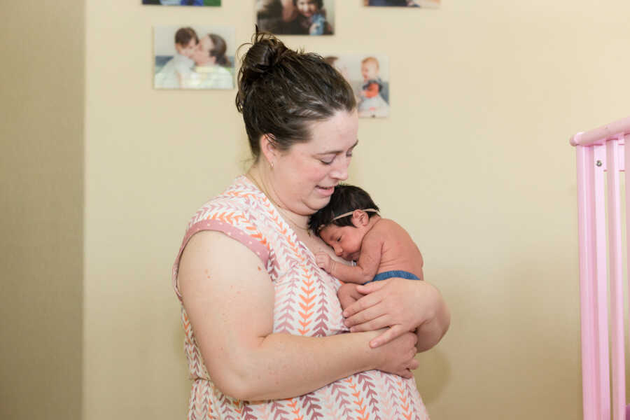 foster mom holds baby girl placement to her chest