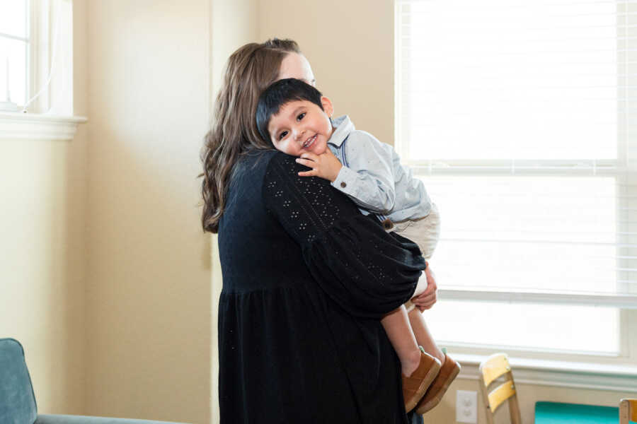 single foster mom holds young boy placement