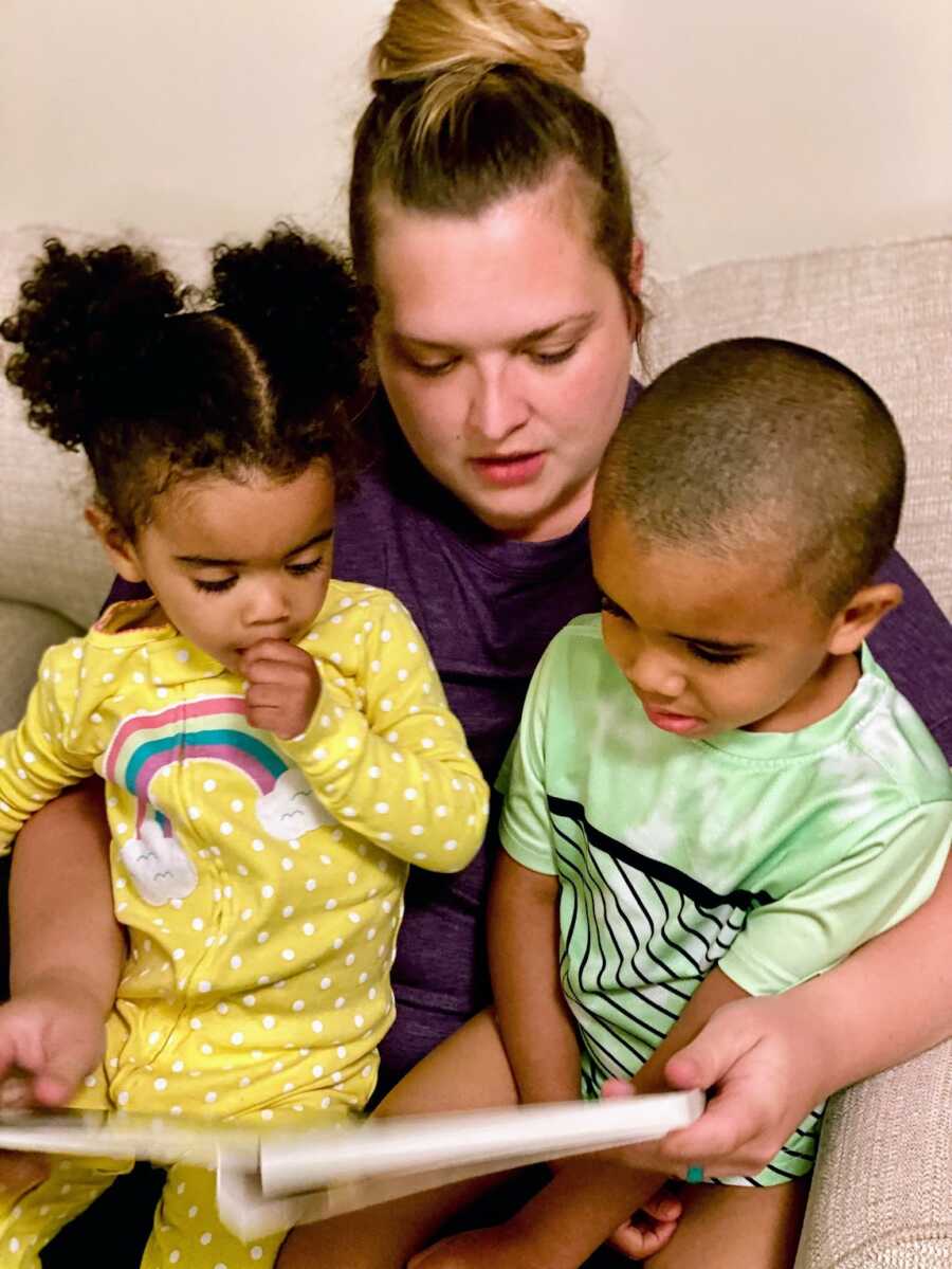 foster mother with her son and daughter in her lap