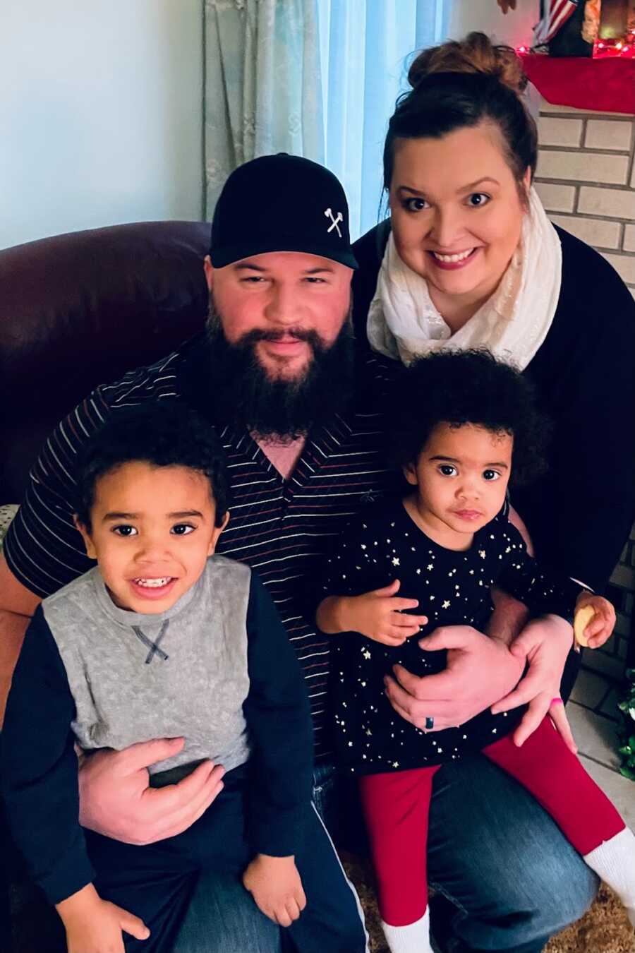 foster parents with foster son and his sister on their laps