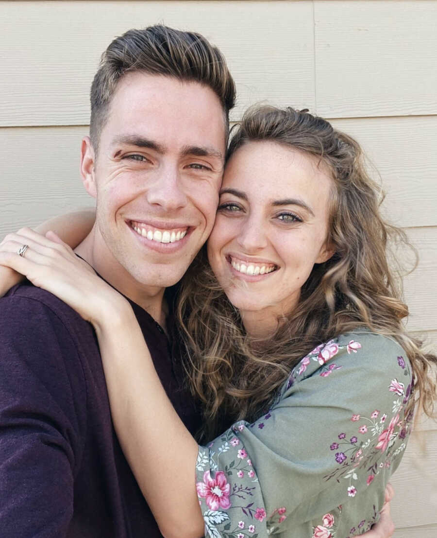 Foster couple hugging and smiling at the beach