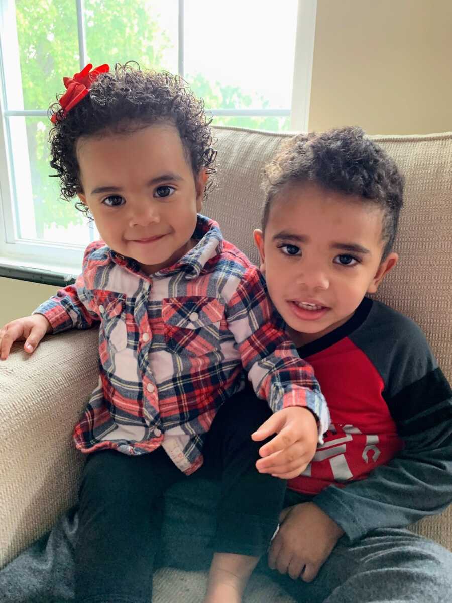 fostered brother and sister sitting in armchair together