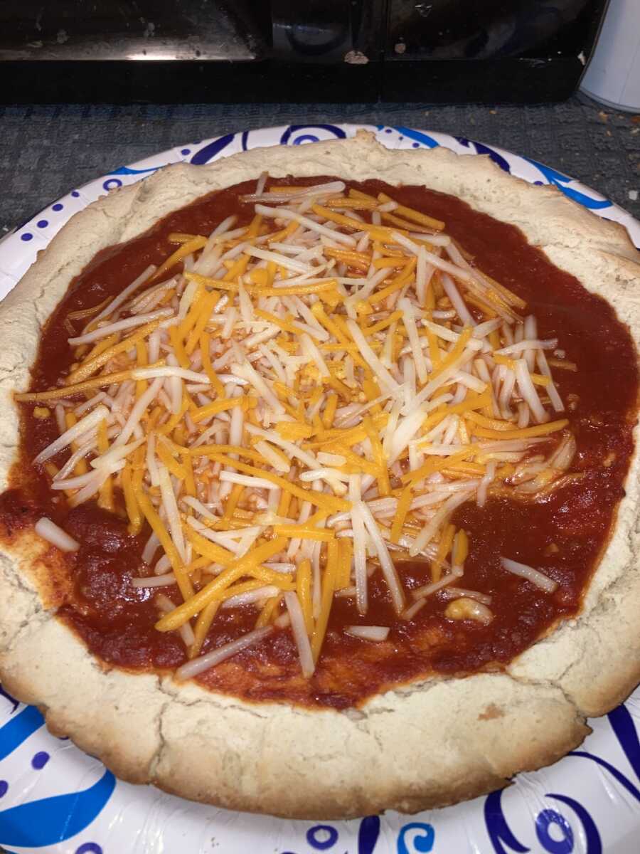 gluten free pizza with sauce and cheese on top