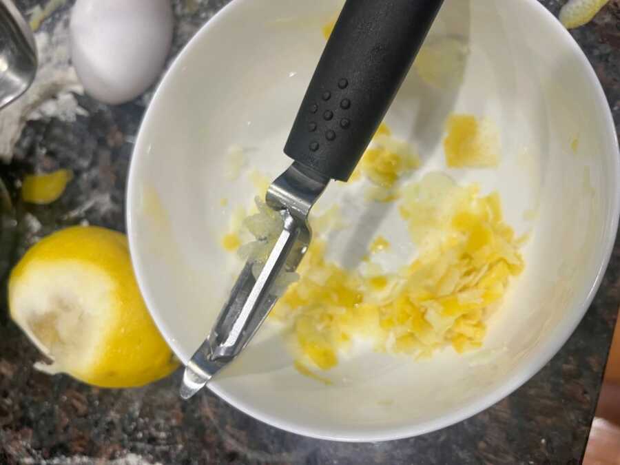 lemon peels in a white mixing bowl for sugar cookies