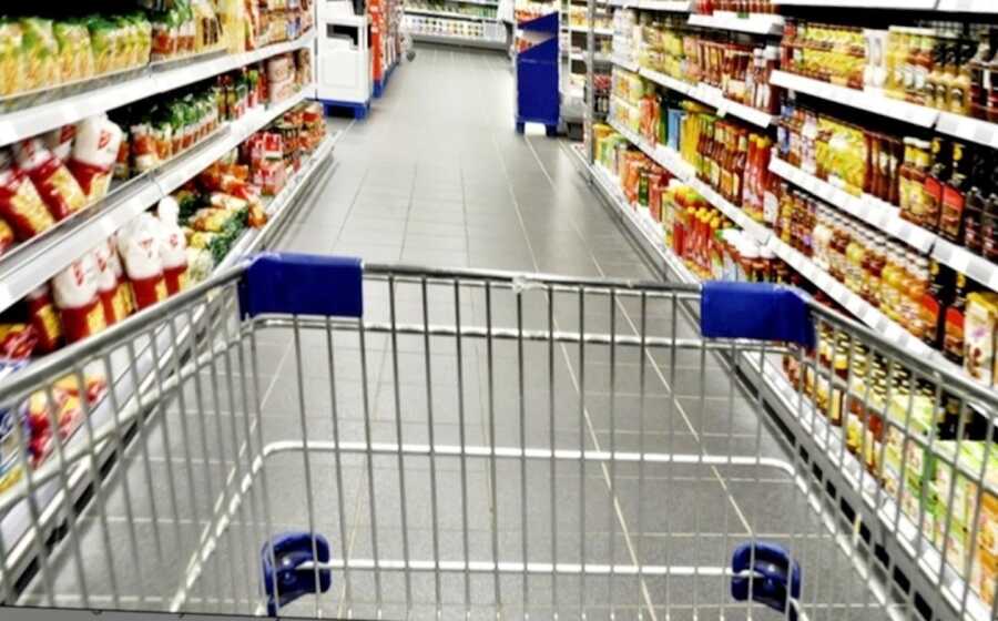 grocery cart being pushed down store aisle
