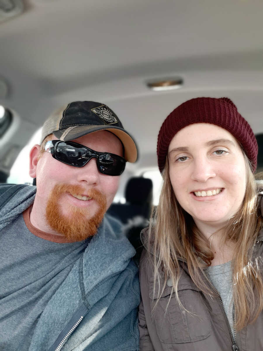 husband and wife sit together while in the car