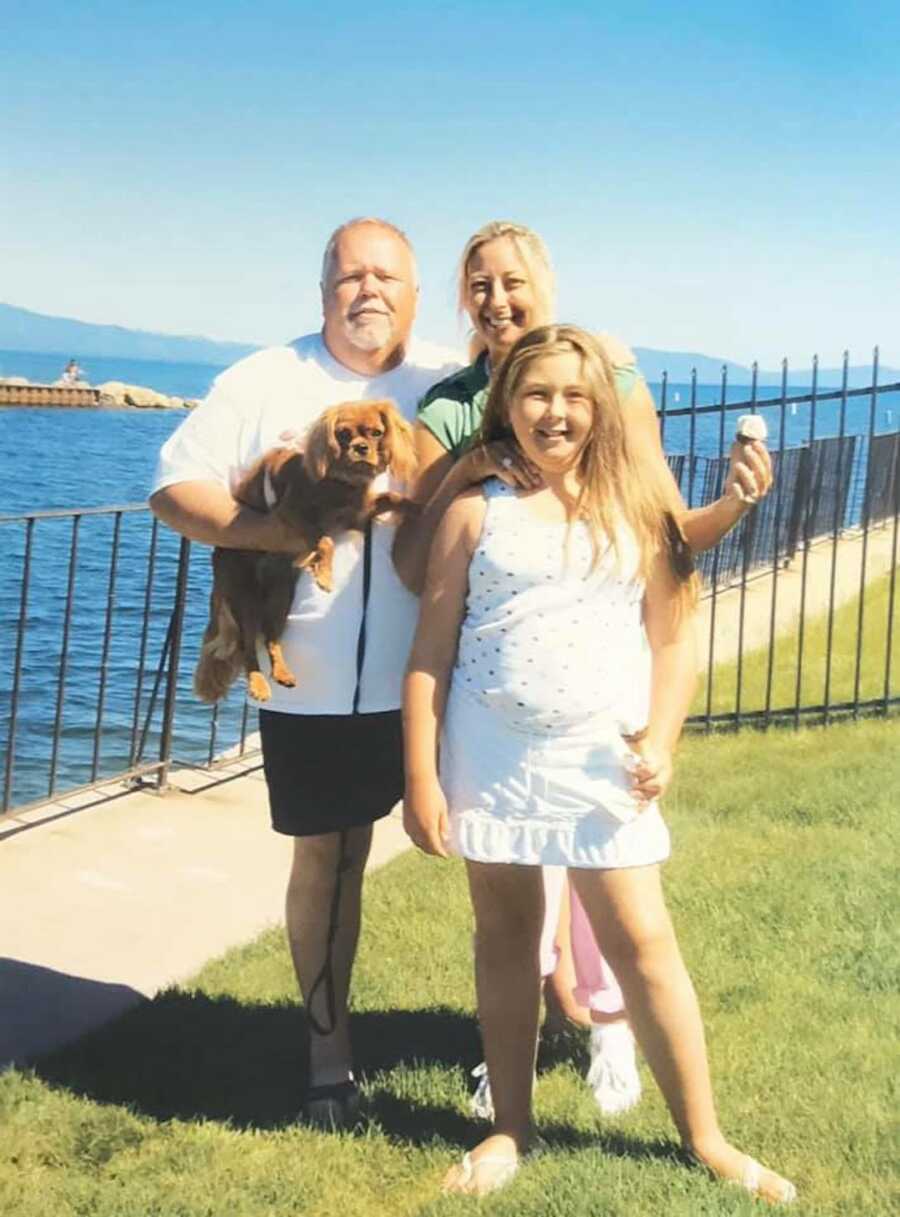 family photo with parents, daughter and family dog