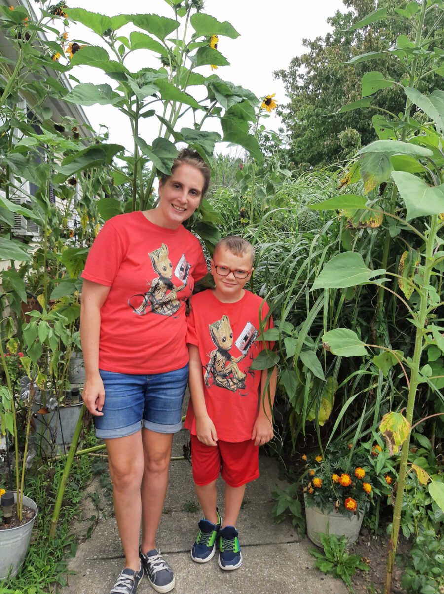 adoptive mother standing with her son wearing matching shirts