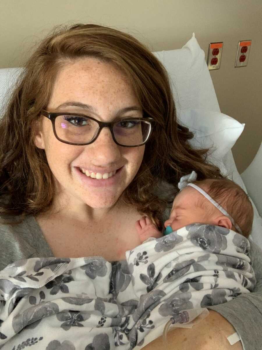 Mother holding newborn baby after giving birth
