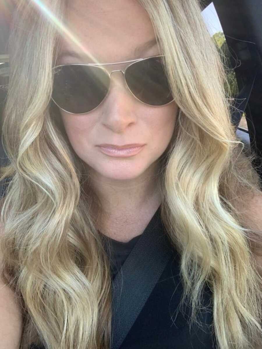 mother sitting in car wearing shades