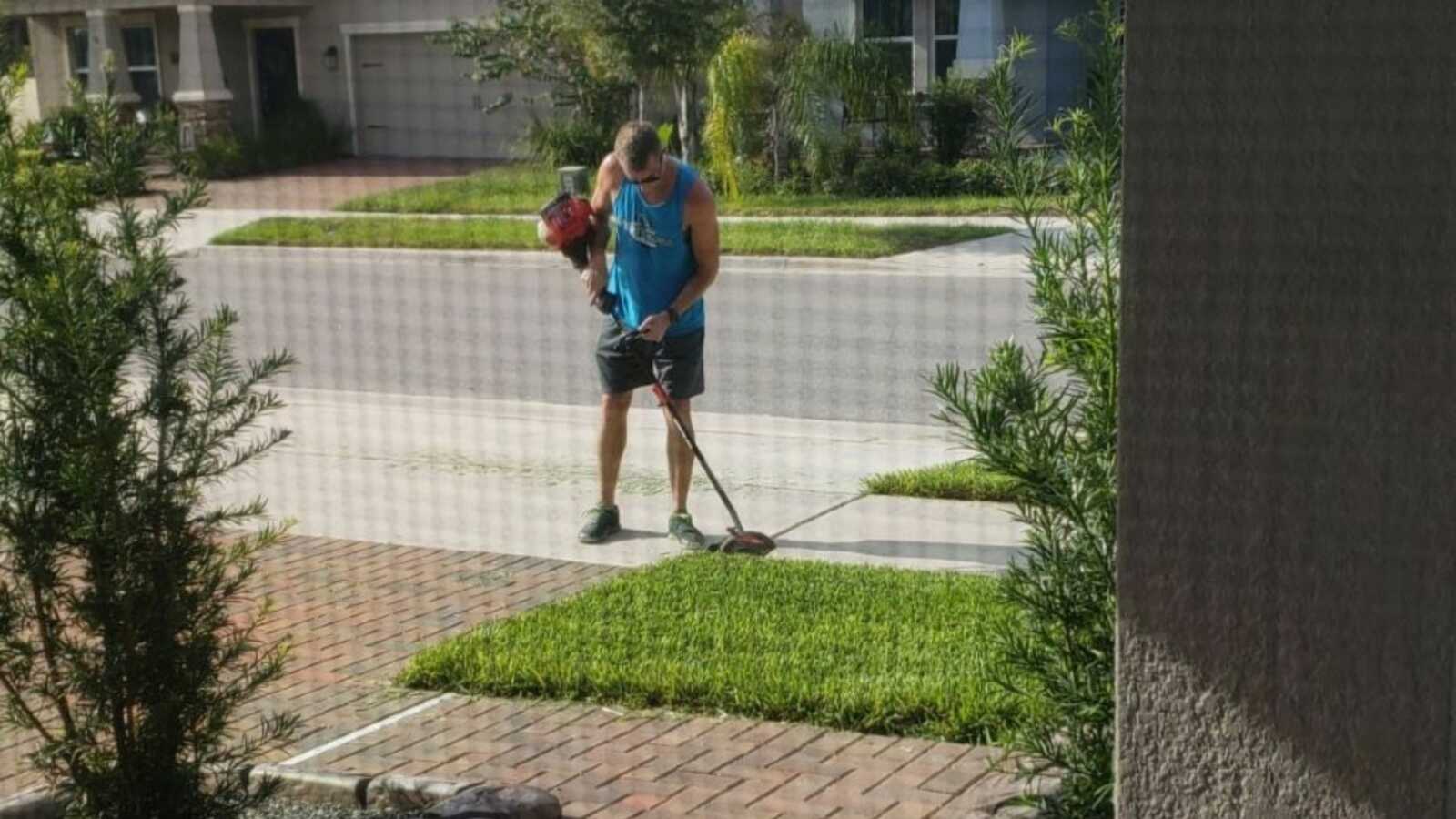 Kind neighbor cutting grass for family