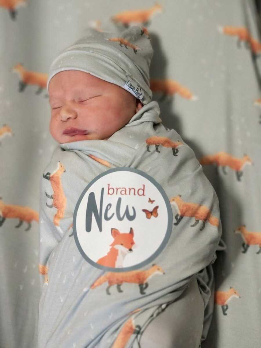 Newborn baby sleeping wrapped up in blanket