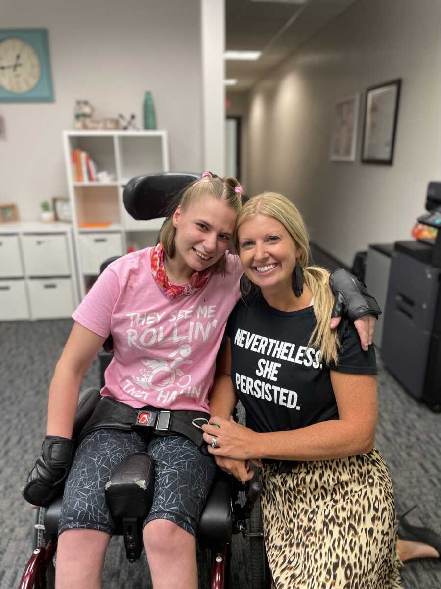 Non-profit owner poses with teen girl in a wheelchair