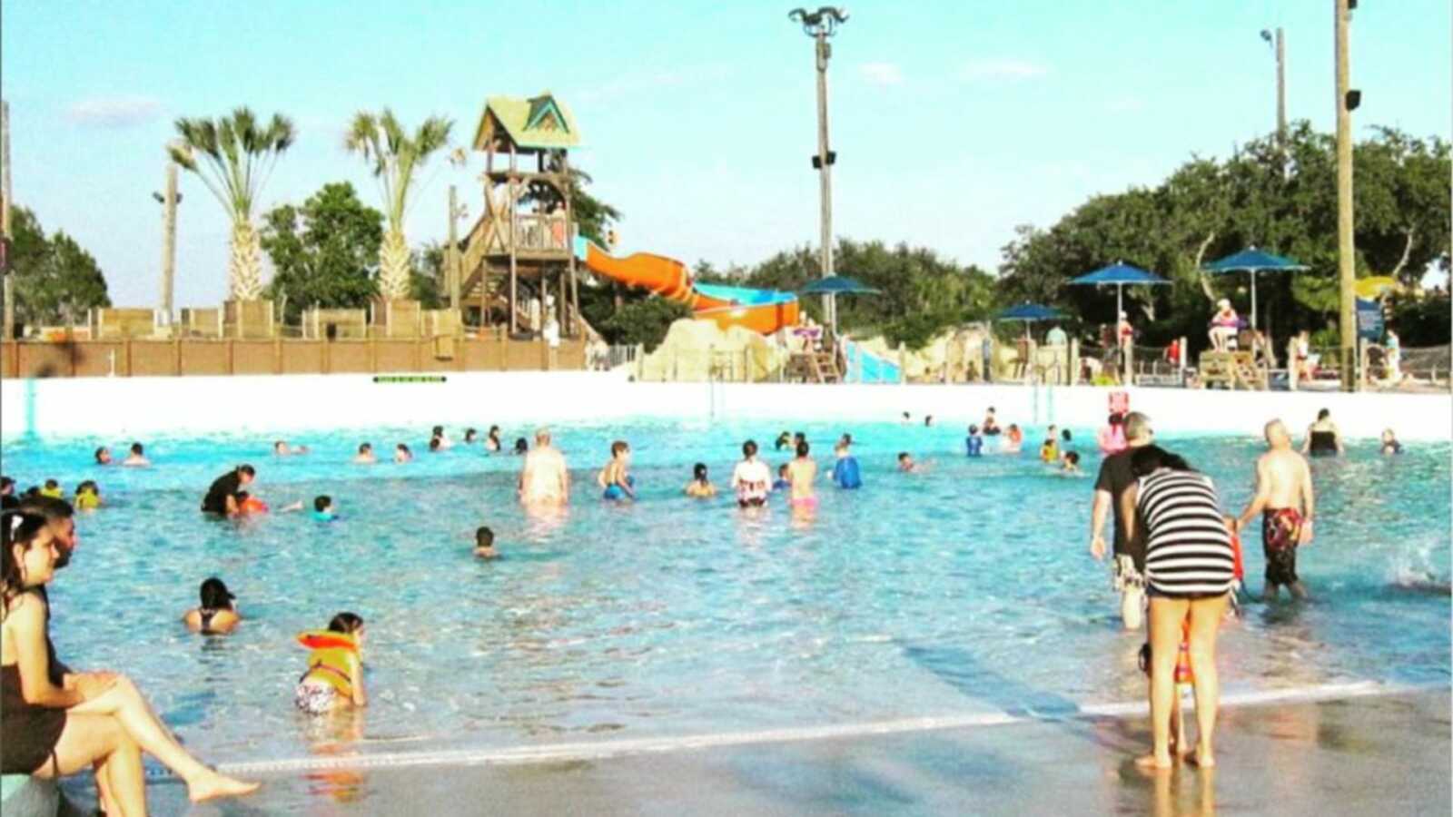 People at the water park scattered throughout pool