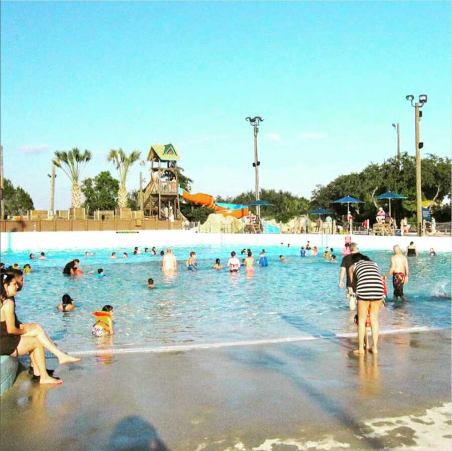 People at the water park scattered throughout pool