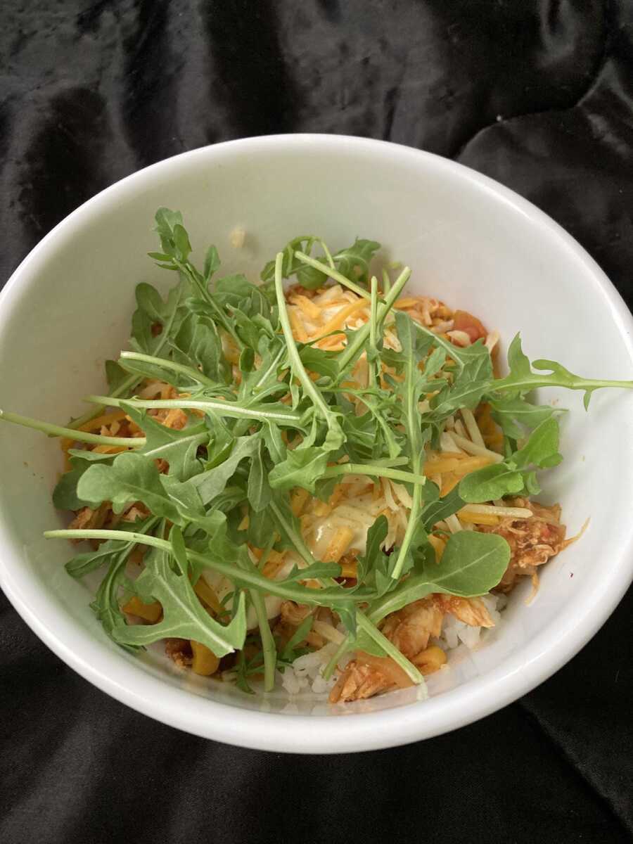 rice bowl with toppings and arugula 